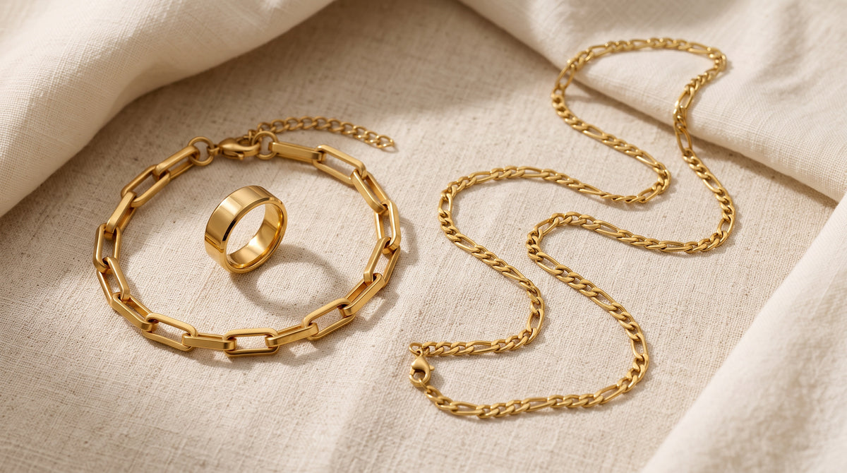 Steel bracelet, band ring and gold-tone chain on cream linen, a guide to whether stainless steel tarnishes