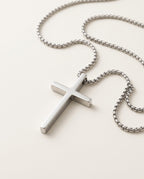 Men's cross necklace in polished stainless steel, packshot