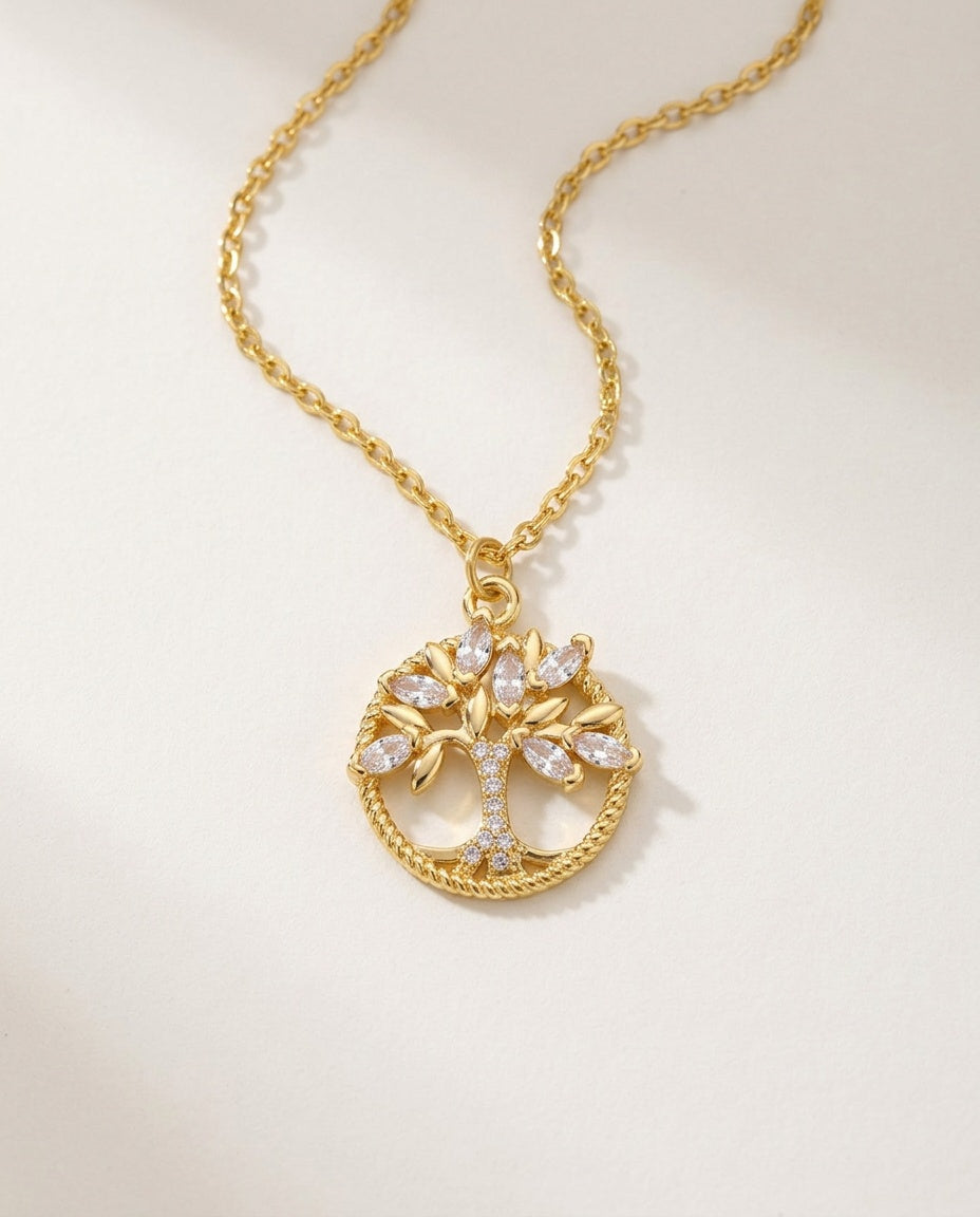 Tree of life necklace in gold with zircon stones on a white background