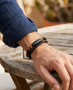 Double-strand stone and leather bracelet worn on a man's wrist