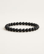 Onyx bracelet with matte black round beads on a white background