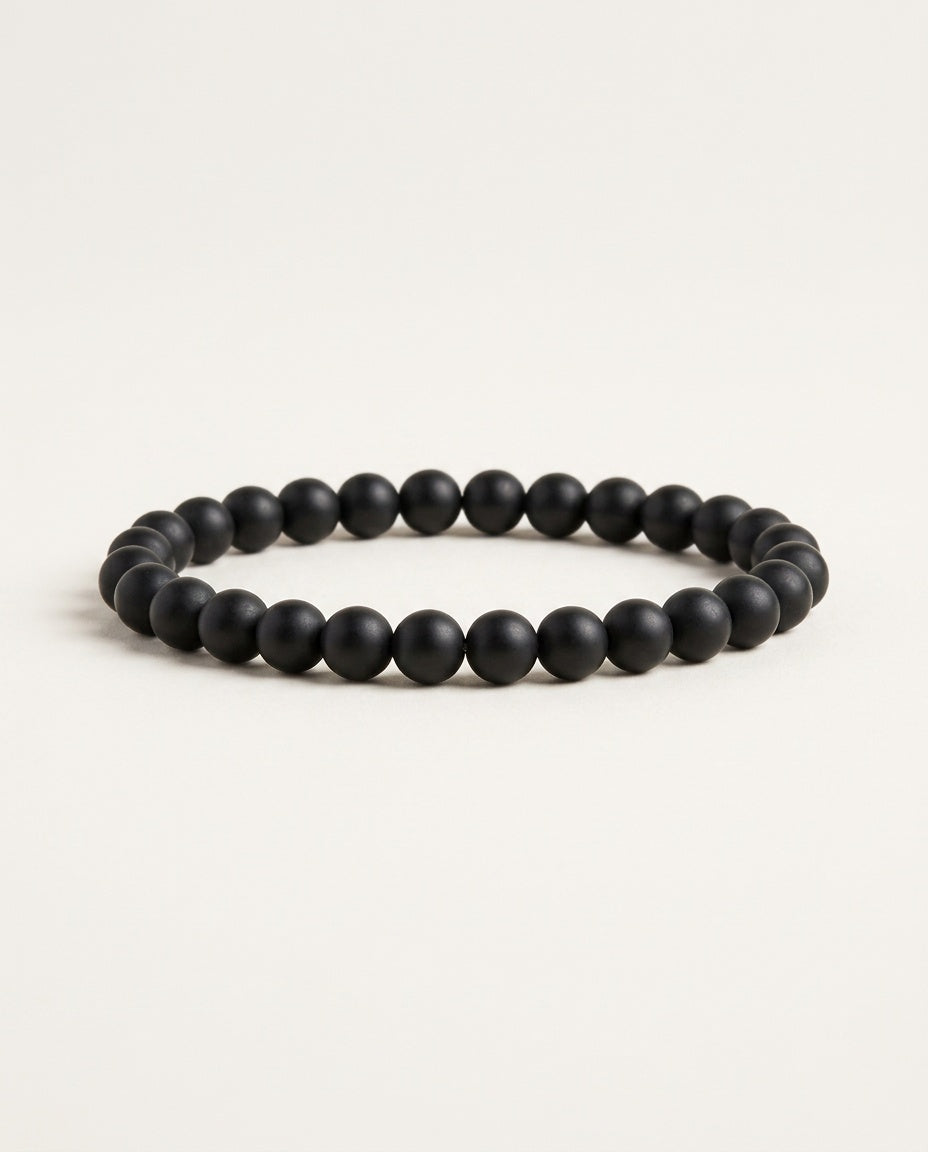 Onyx bracelet with matte black round beads on a white background
