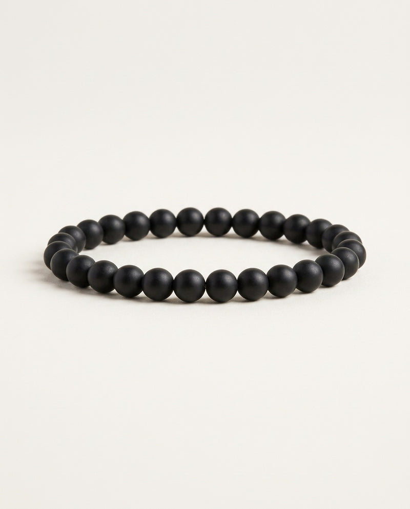 Onyx bracelet with matte black round beads on a white background