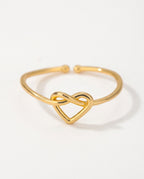 Heart ring with a knotted heart on a fine open band, packshot