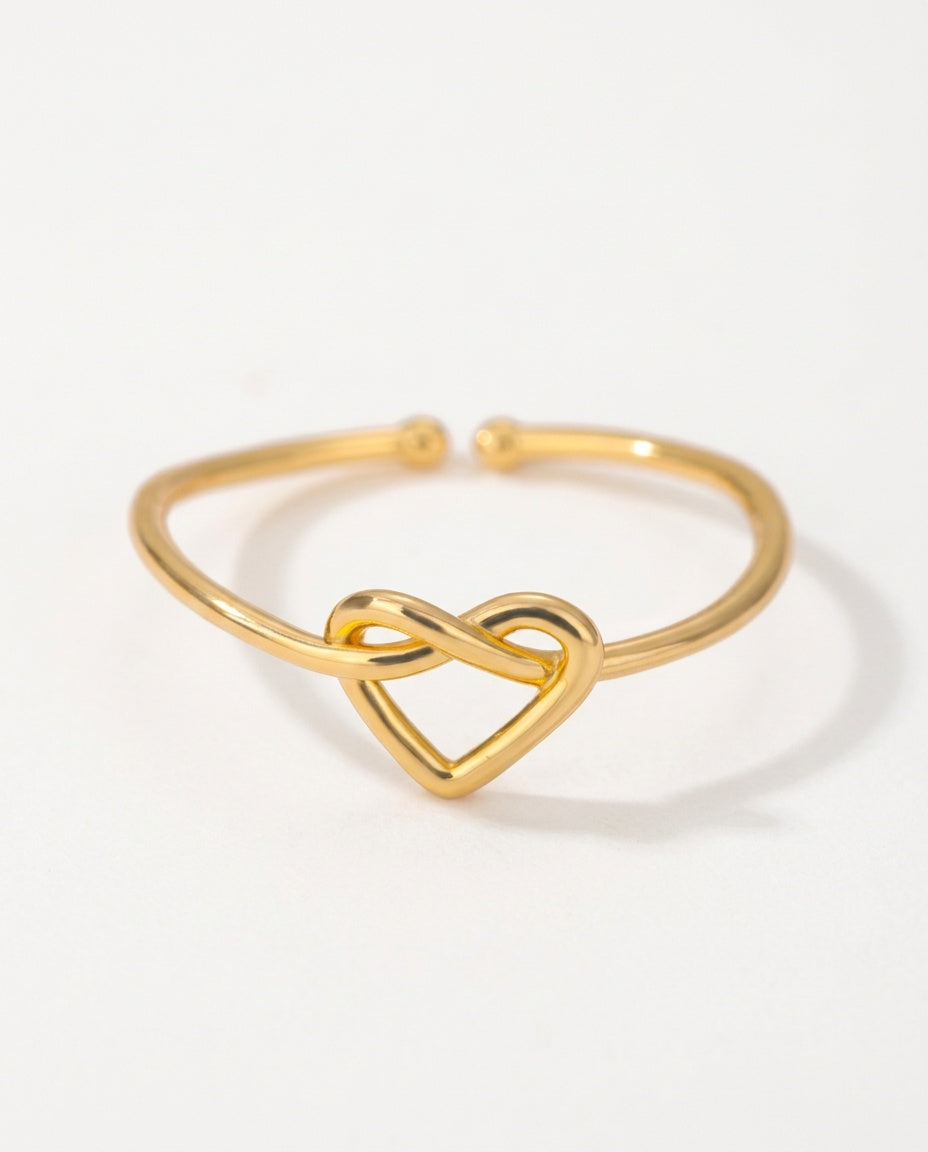 Heart ring with a knotted heart on a fine open band, packshot