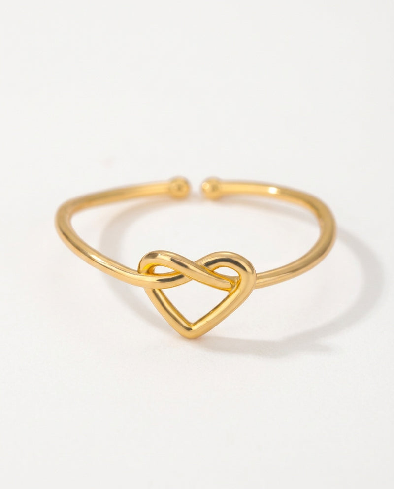 Heart ring with a knotted heart on a fine open band, packshot