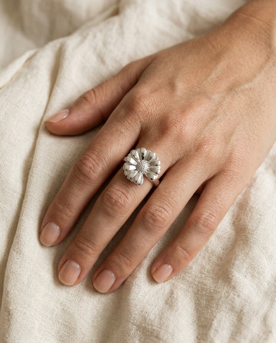 Statement daisy ring worn on the middle finger