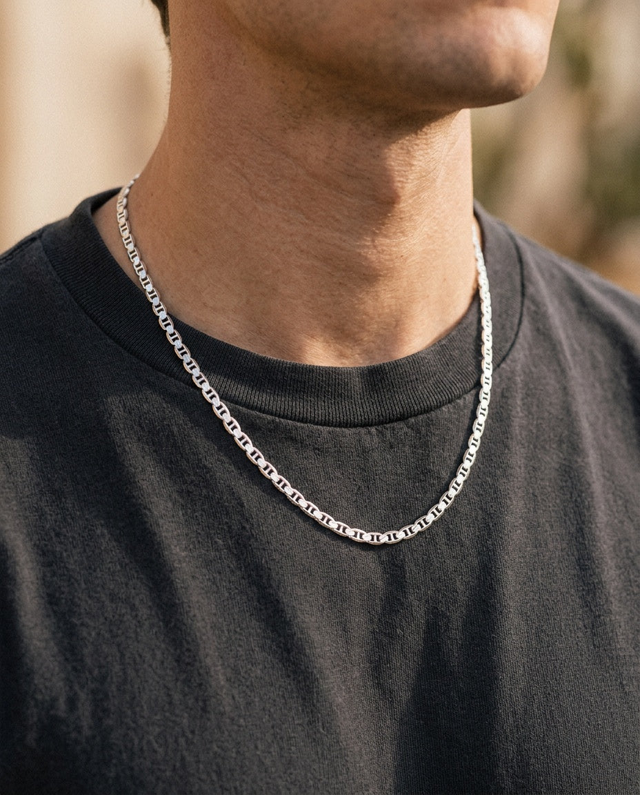 Silver mariner chain worn over a white T-shirt