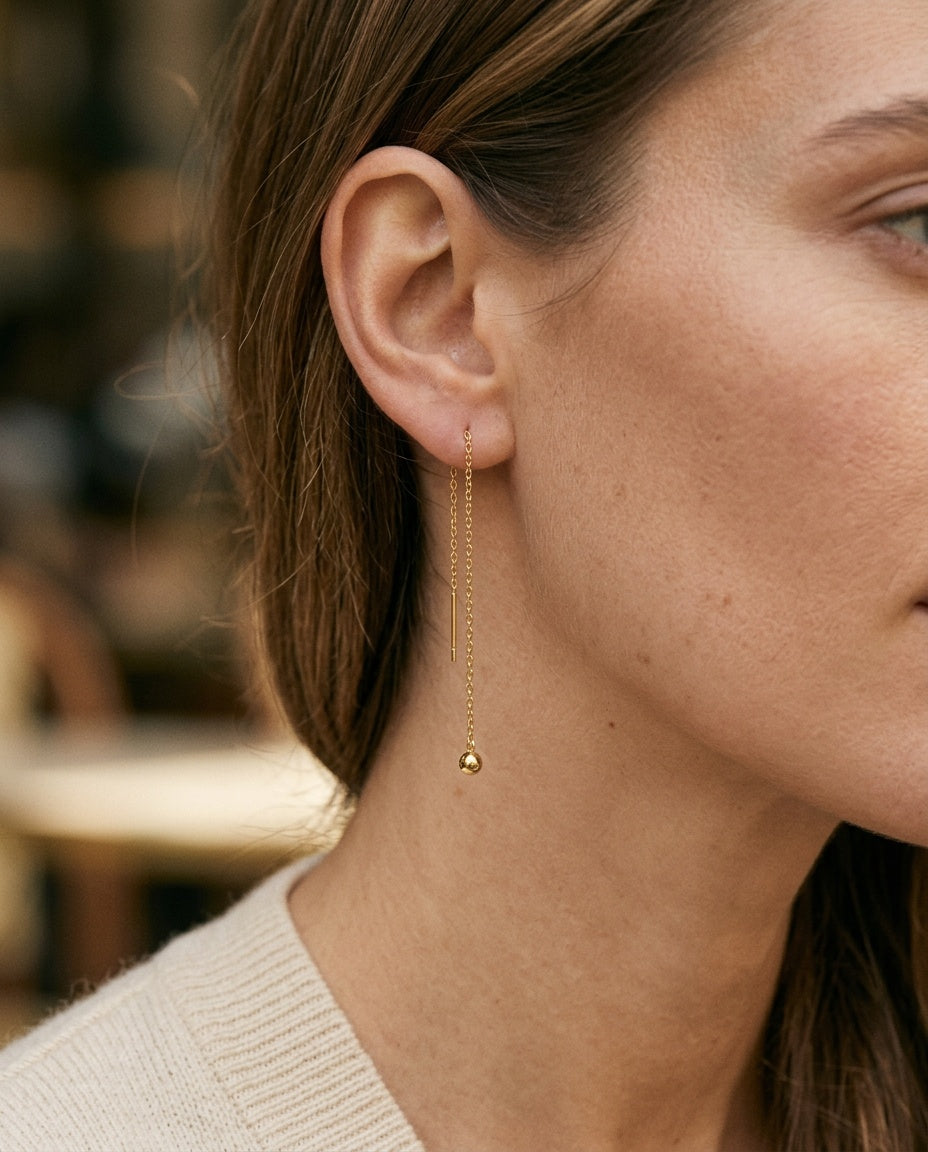 Chain earring worn across a double lobe piercing