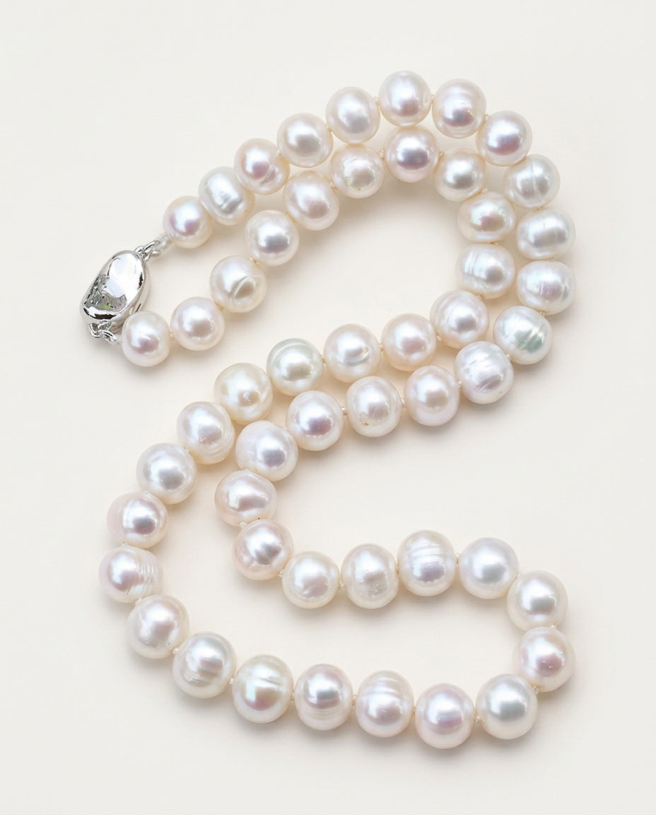 Large pearl necklace of white freshwater pearls on a soft background