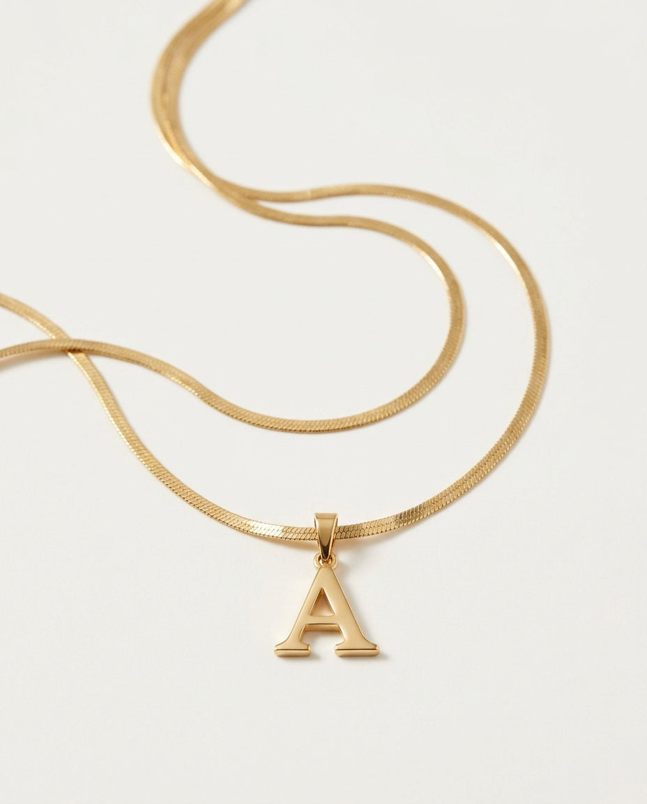 Gold initial necklace with a small letter pendant on a fine box chain