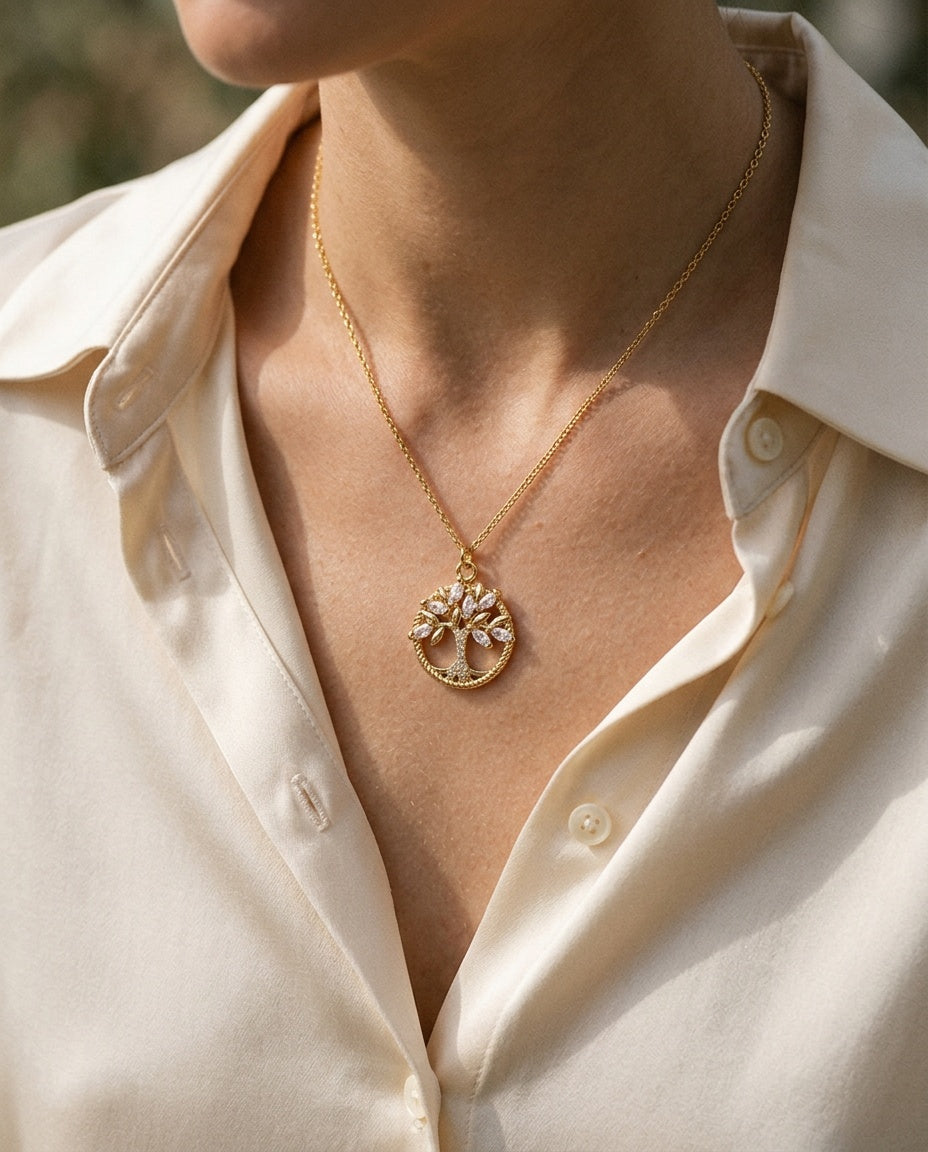 Gold round tree pendant worn on a bare neckline