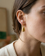 Teardrop clip-on earring worn on an unpierced ear