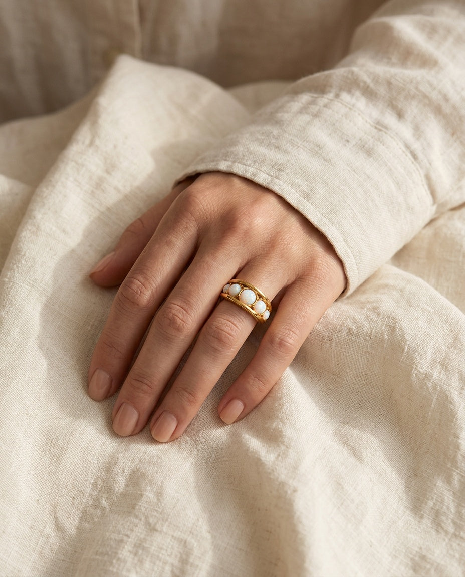 Gold opal ring worn on the ring finger
