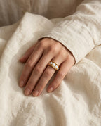 Gold opal ring worn on the ring finger