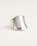 Sterling silver thumb ring, wide polished band on a white background