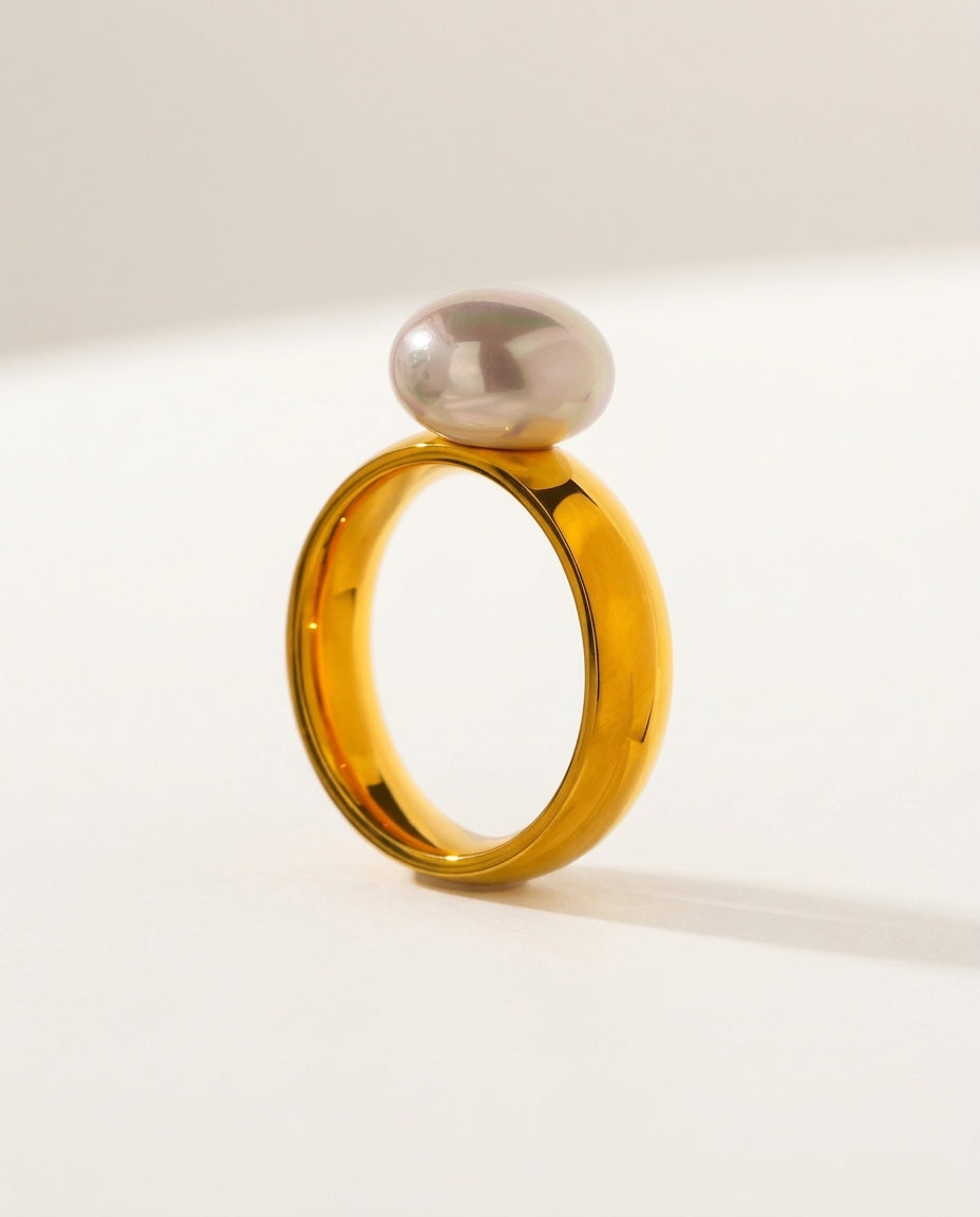 Gold pearl ring with a round shell pearl on a smooth band