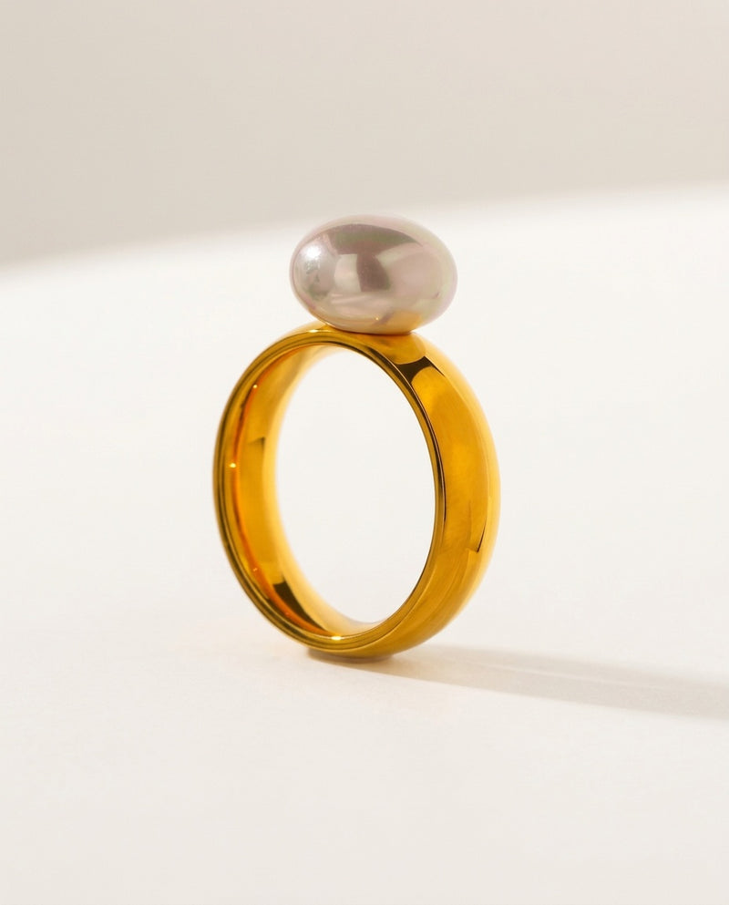 Gold pearl ring with a round shell pearl on a smooth band