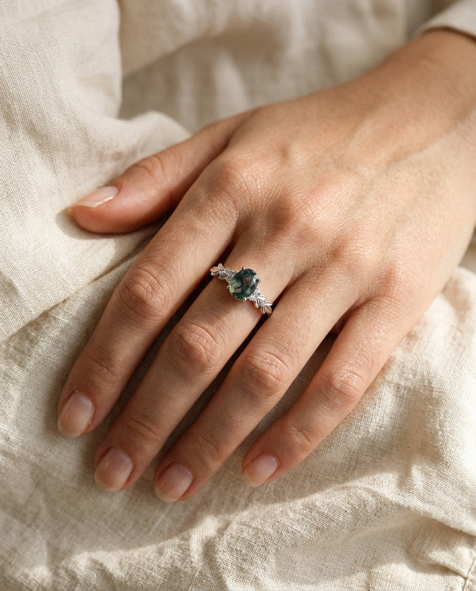 Moss agate ring worn on the ring finger