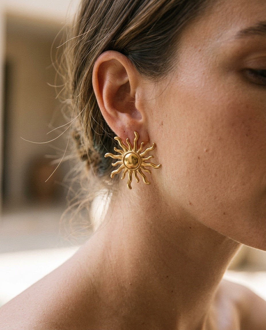 Sun earrings worn with hair pulled back