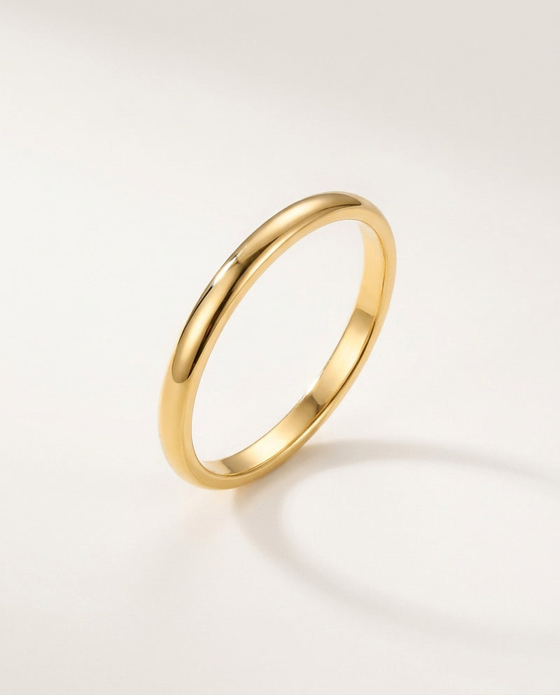 Gold band ring, slim 2 mm polished band on a white background