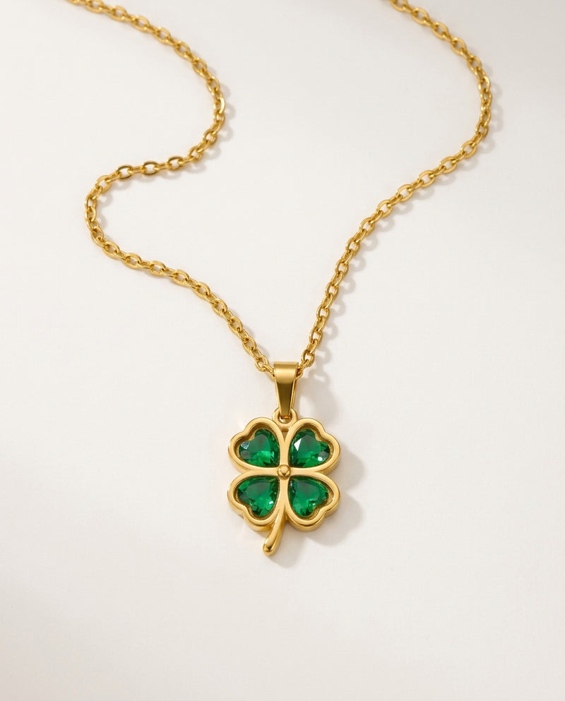 Gold clover necklace with a green four-leaf clover pendant