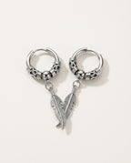 Mens dangle earrings with a stainless steel feather on an engraved hoop, packshot