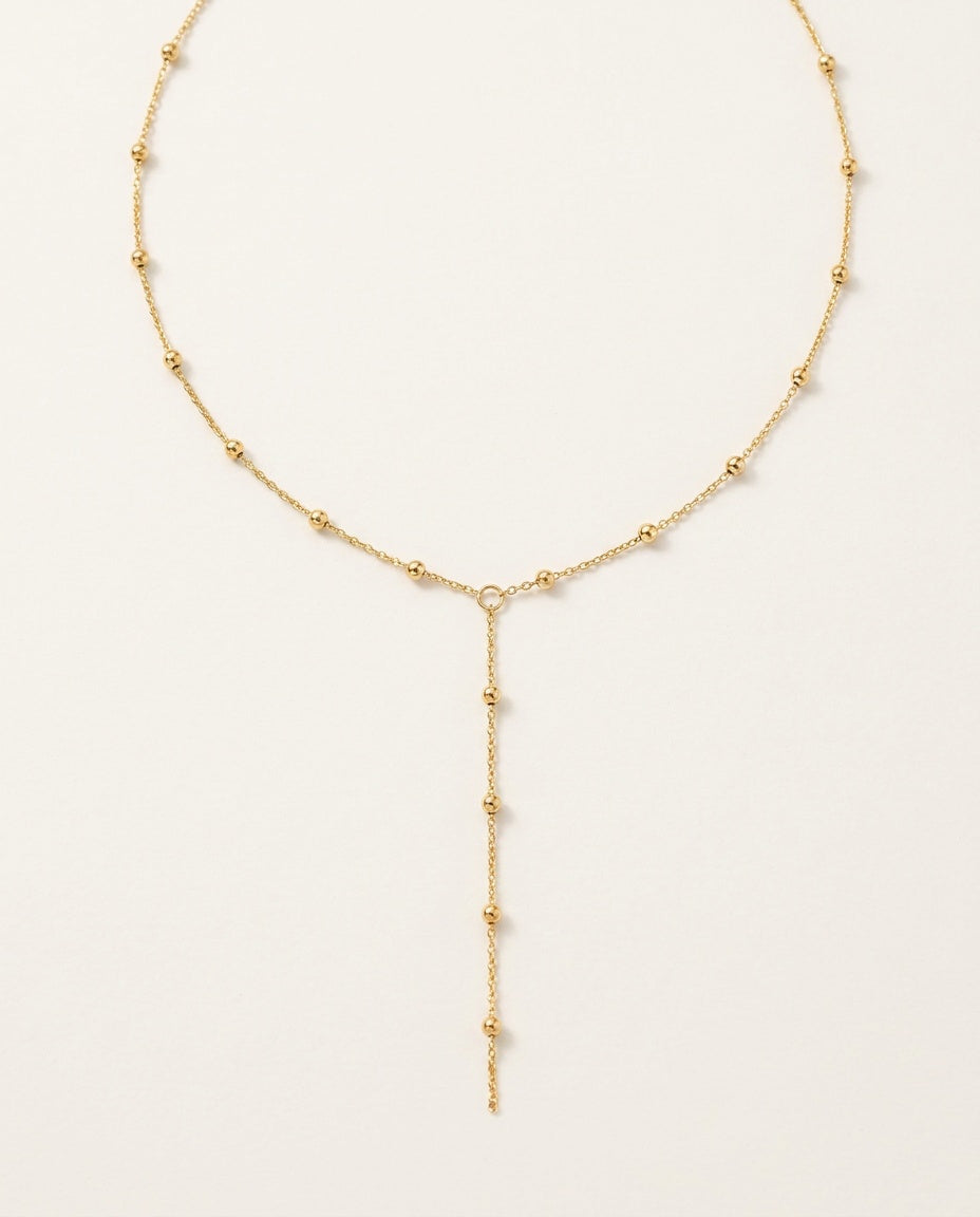 Gold lariat necklace with a fine Y chain and delicate central drop