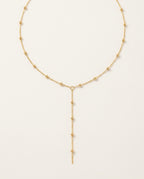 Gold lariat necklace with a fine Y chain and delicate central drop