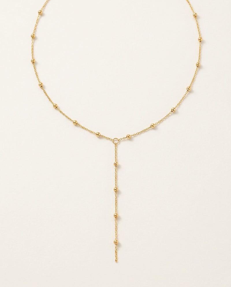 Gold lariat necklace with a fine Y chain and delicate central drop
