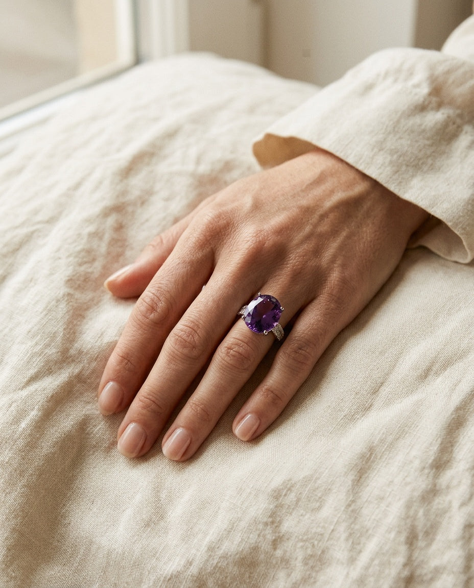 Amethyst ring worn on the index finger