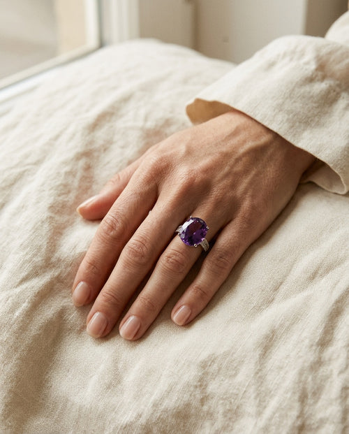Amethyst ring worn on the index finger