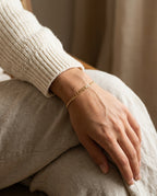Name bracelet worn on a woman's wrist
