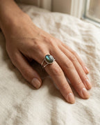 Labradorite ring worn on the ring finger with blue flashes visible