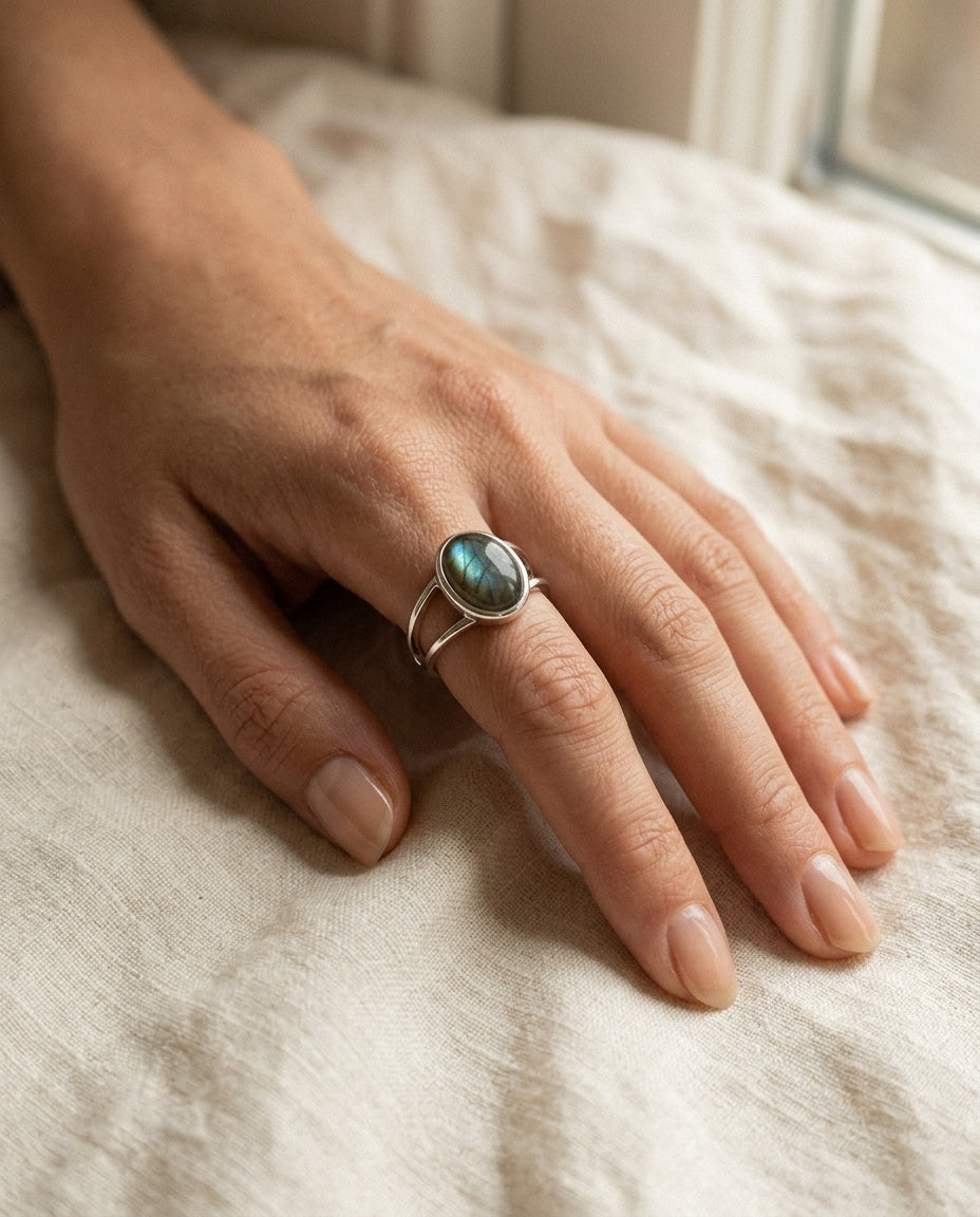Labradorite ring worn on the ring finger with blue flashes visible