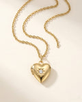 Gold heart photo locket necklace with a small starburst-set stone