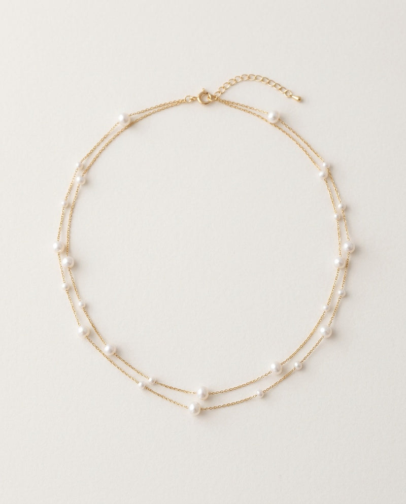 Pearl choker with small white pearls on a fine gold chain