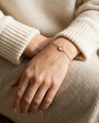 Rose quartz bracelet worn on a woman’s wrist