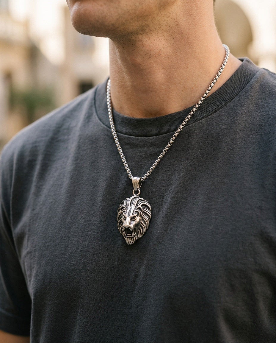 Lion pendant necklace worn by a man over a dark T-shirt