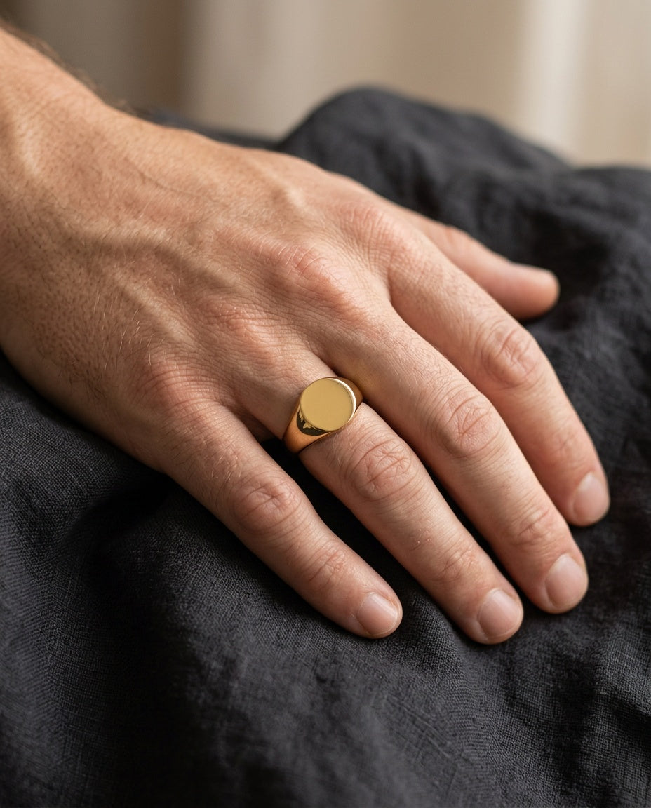 Signet ring worn on a man's little finger
