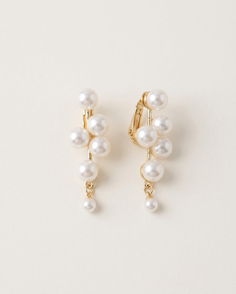 Pearl clip on earrings in six styles on a light background