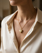 Photo locket necklace worn just below the collarbone