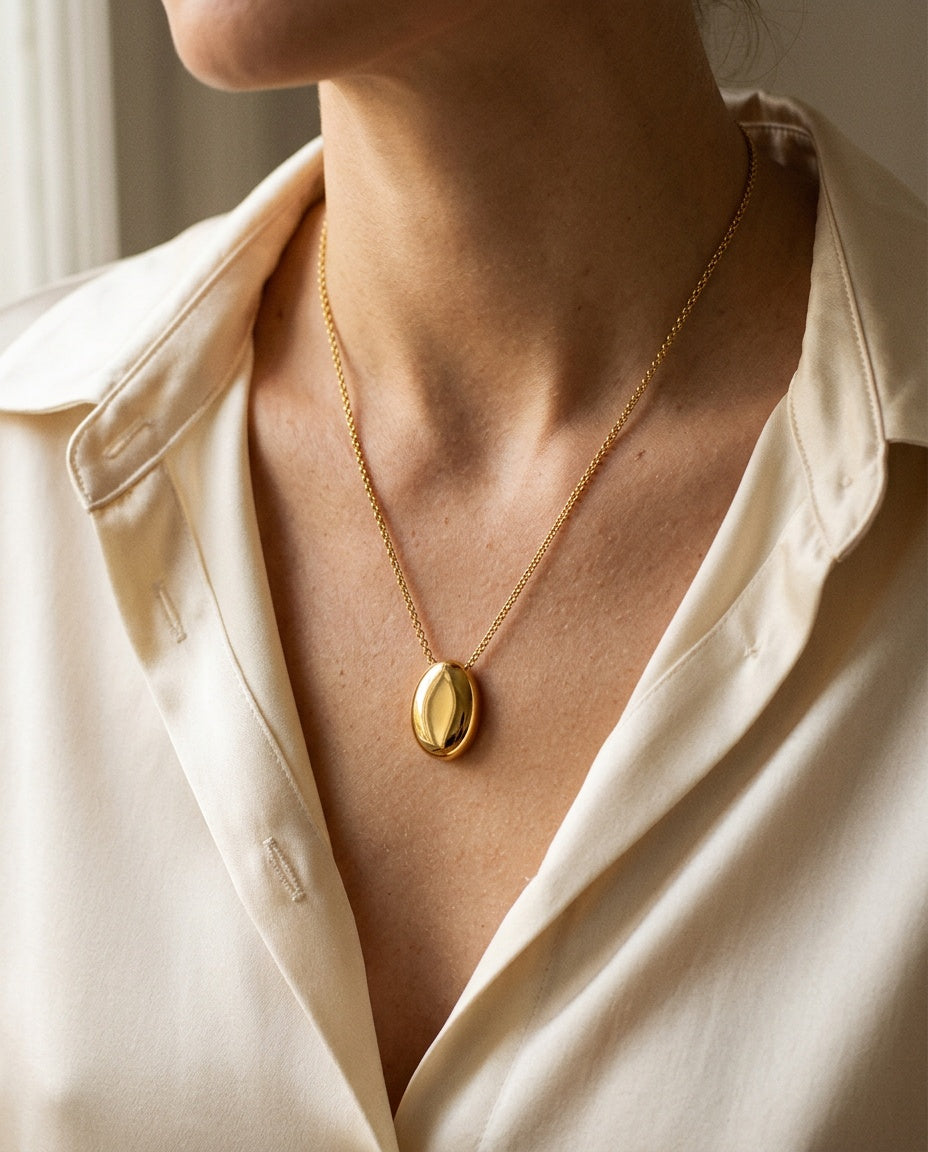Sautoir pendentif porté sur un pull en maille fine
