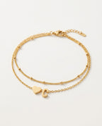 Initial bracelet with heart and letter on two gold chains, packshot