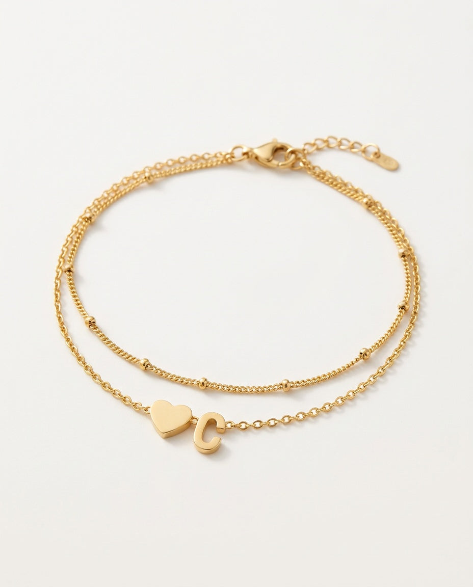 Initial bracelet with heart and letter on two gold chains, packshot