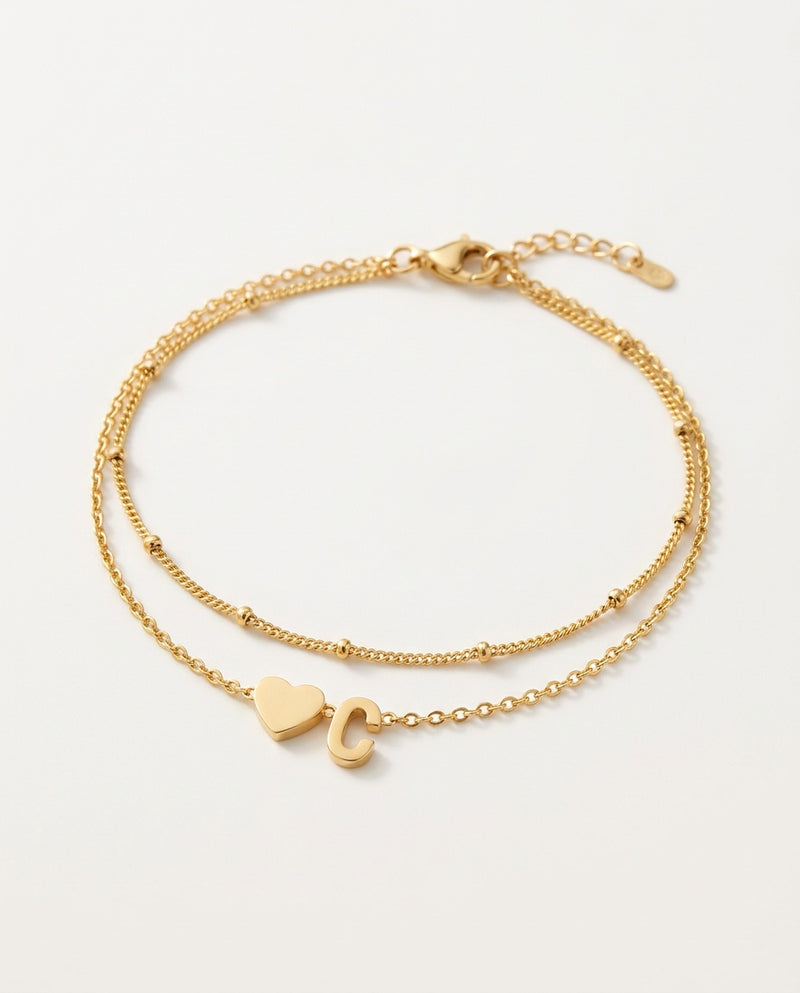 Initial bracelet with heart and letter on two gold chains, packshot