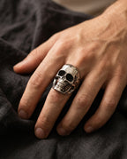 Man wearing a sculpted steel skull on his middle finger