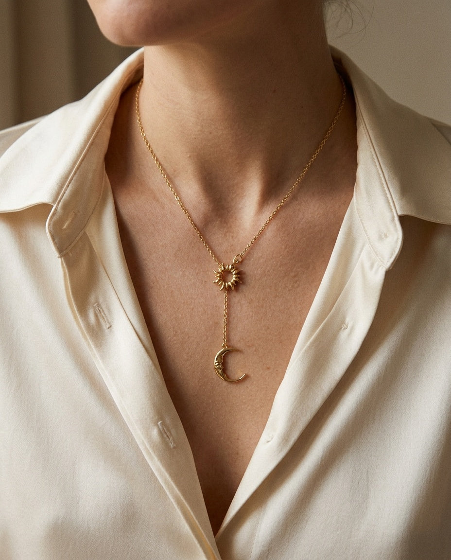 Sun and moon necklace worn over a V-neck top