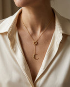 Sun and moon necklace worn over a V-neck top