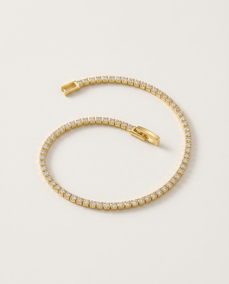 Gold tennis bracelet with a row of 2.5 mm cubic zirconia stones